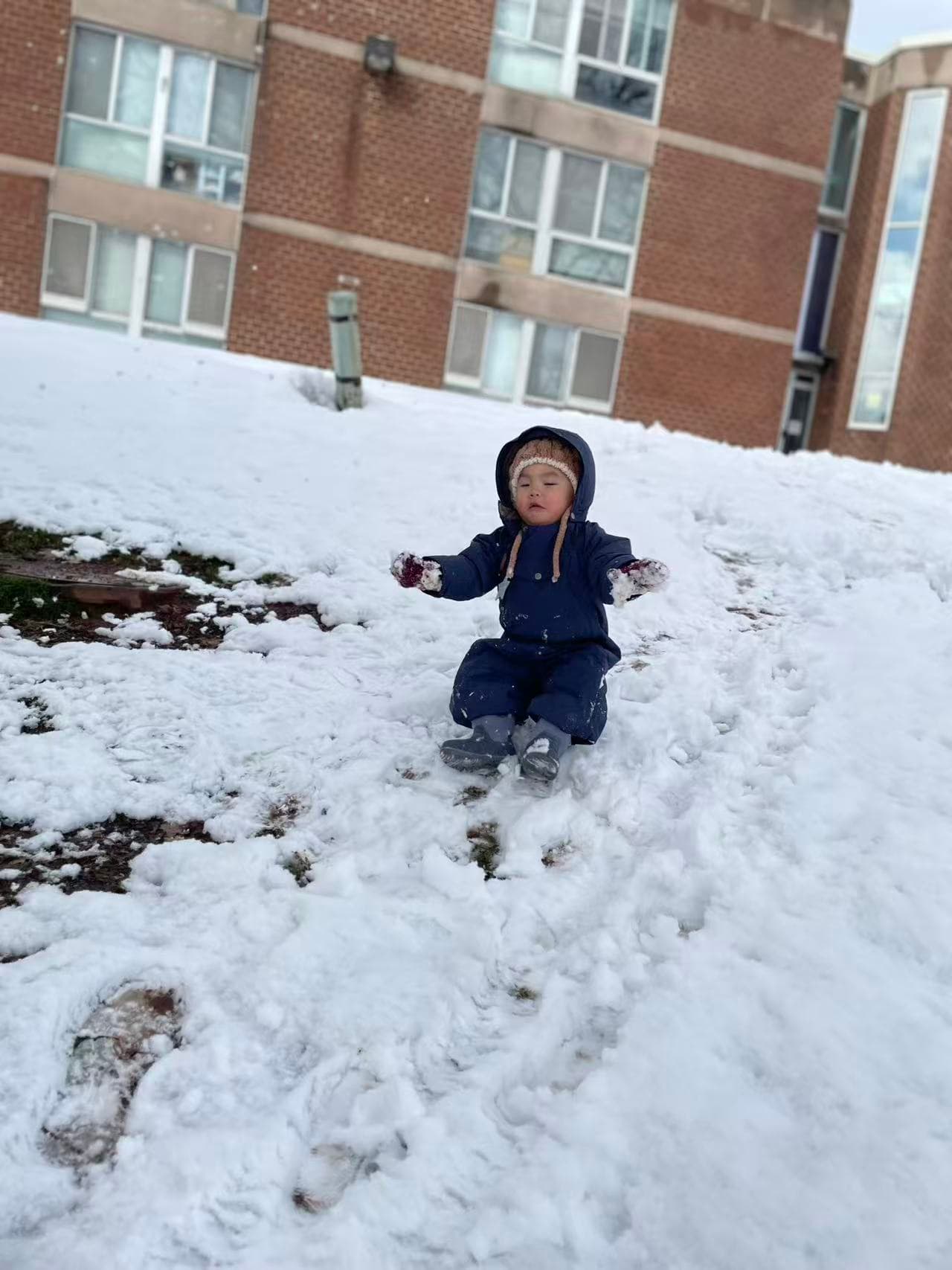 Lev REC snow play sitting outdoors